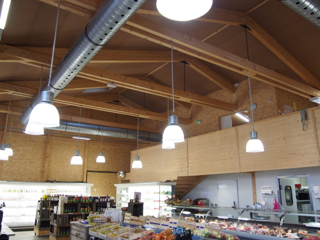 Intérieur de bâtiment commercial avec charpente en bois apparente